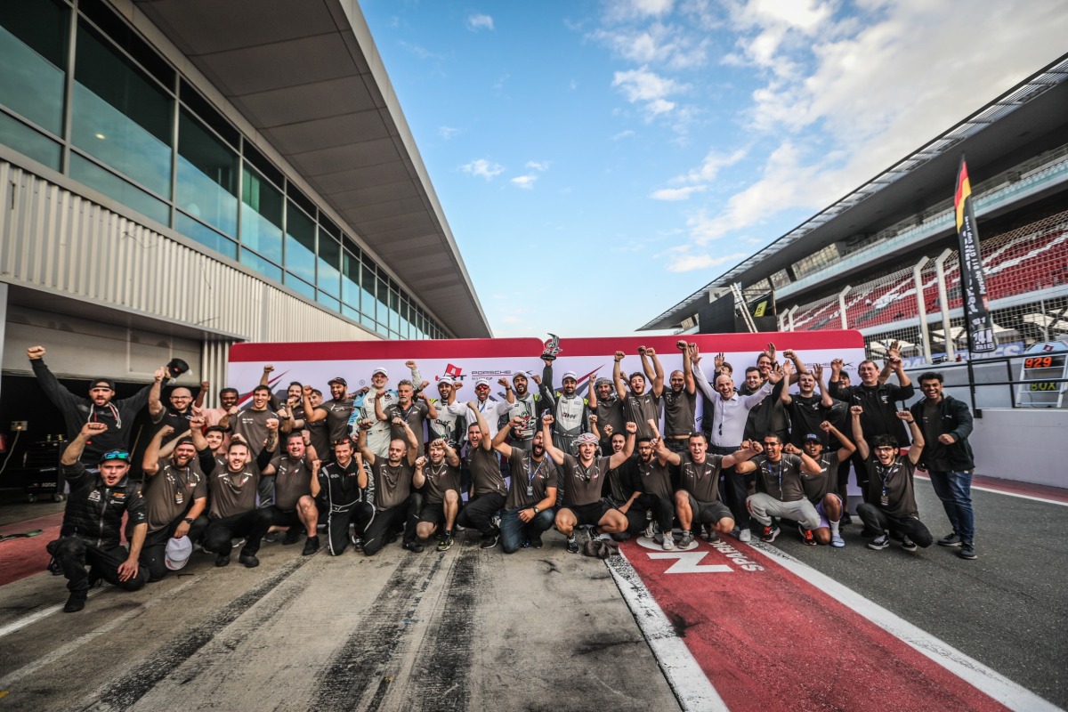 Members and officials of the two QMMF teams celebrate after the 18th Hankook 24H Dubai endurance race.
