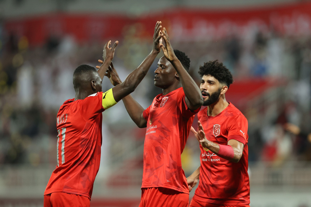 Al Duhail's Michael Olunga celebrates with teammates.