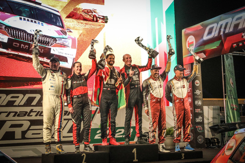 Qatar's Nasser Al Attiyah and co-driver Mathieu Baumel celebrate with other podium winners.