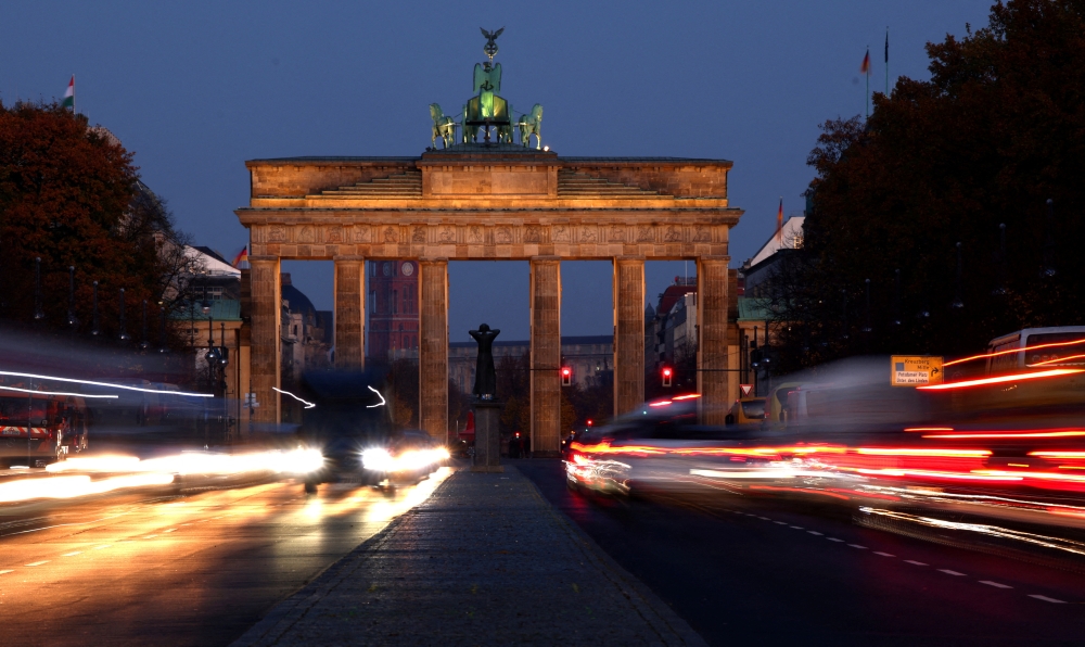 Car traffic makes its way on a road in front of the illuminated Brandenburg Gate, in central Berlin, Germany, November 15, 2022. REUTERS/Lisi Niesner/File Photo