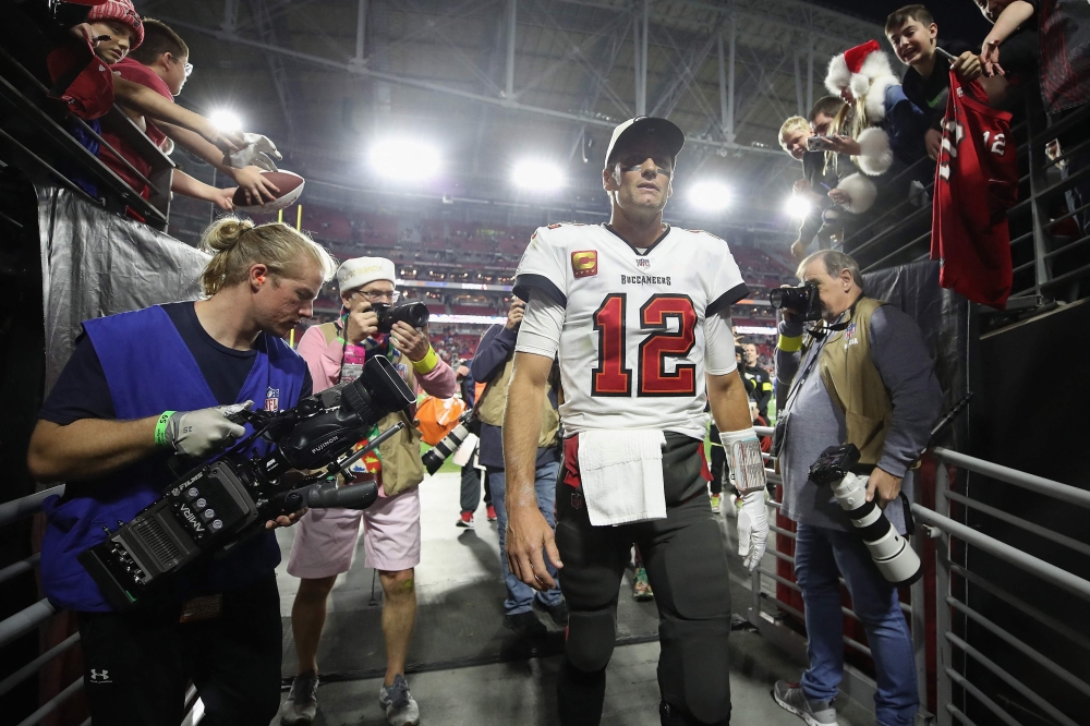 In this file photo taken on December 25, 2022, Quarterback Tom Brady of the Tampa Bay Buccaneers walks off the field following the NFL game at State Farm Stadium in Glendale, Arizona. - Brady announced his retirement on February 1, 2023, at the age of 45 after a storied career that included a record-breaking seventh Super Bowl victory in 2021 and a temporary retirement last year. 