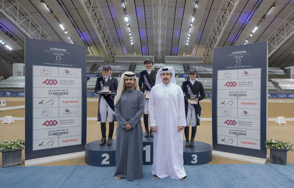 The podium winners of dressage competitions pose with officials during the presentation ceremony.