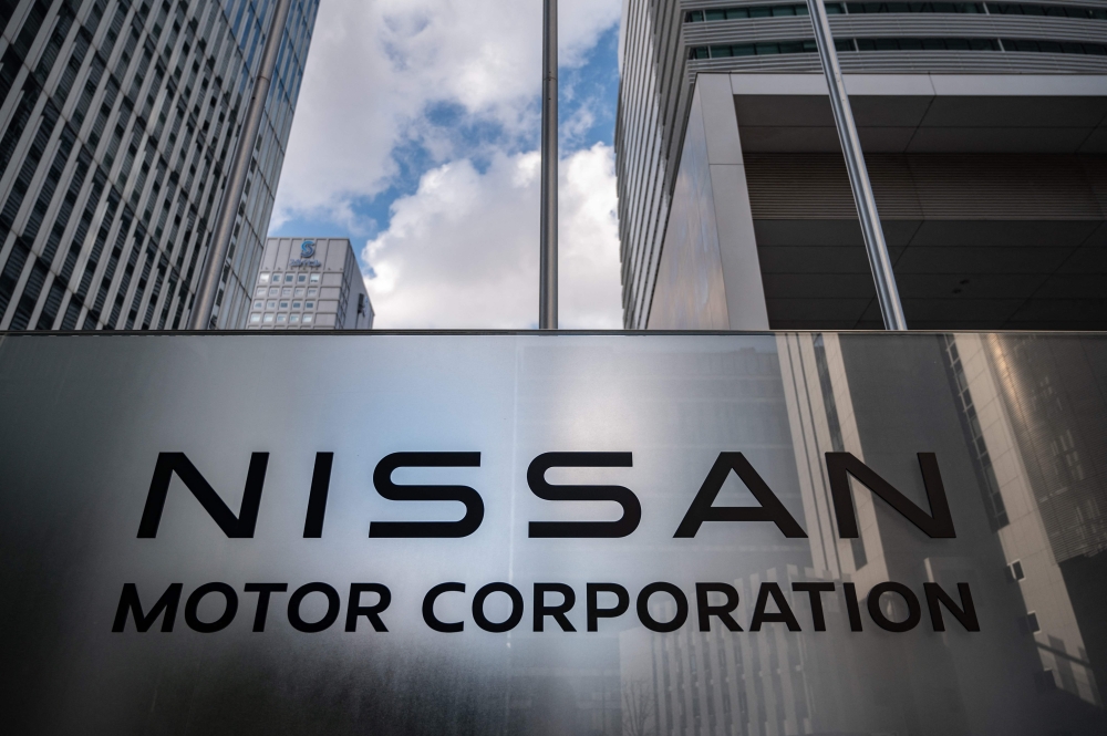 This picture taken on February 4, 2023 shows signage of Japanese automaker Nissan Motor at the company's head office in Yokohama. (Photo by Yuichi YAMAZAKI / AFP)

