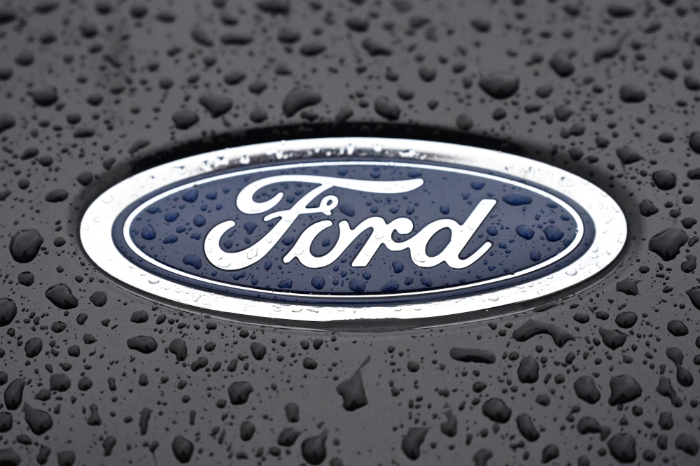 This file photograph taken on October 18, 2021, shows the Ford logo on the front of a vehicle at the company's Halewood plant in Liverpool, north-west England. Photo by Paul ELLIS / AFP