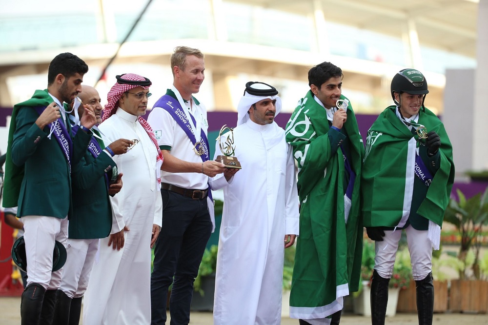 Qatar Equestrian and Modern Pentathlon Federation (QEMPF) President Badr Al Darwish presents the Nations Cup trophy to Saudi Arabia team’s Chef d’Equipe David Will at the Longines Arena at Al Shaqab yesterday. Sami Al Dahami, President of the Seventh Regional Group of the International Equestrian Federation (FEI) is also seen.