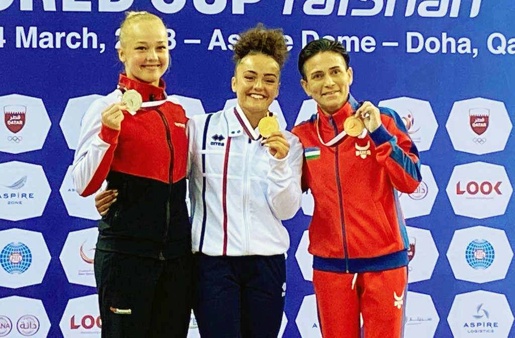 The medal winners of the women’s vault final celebrate on the podium.