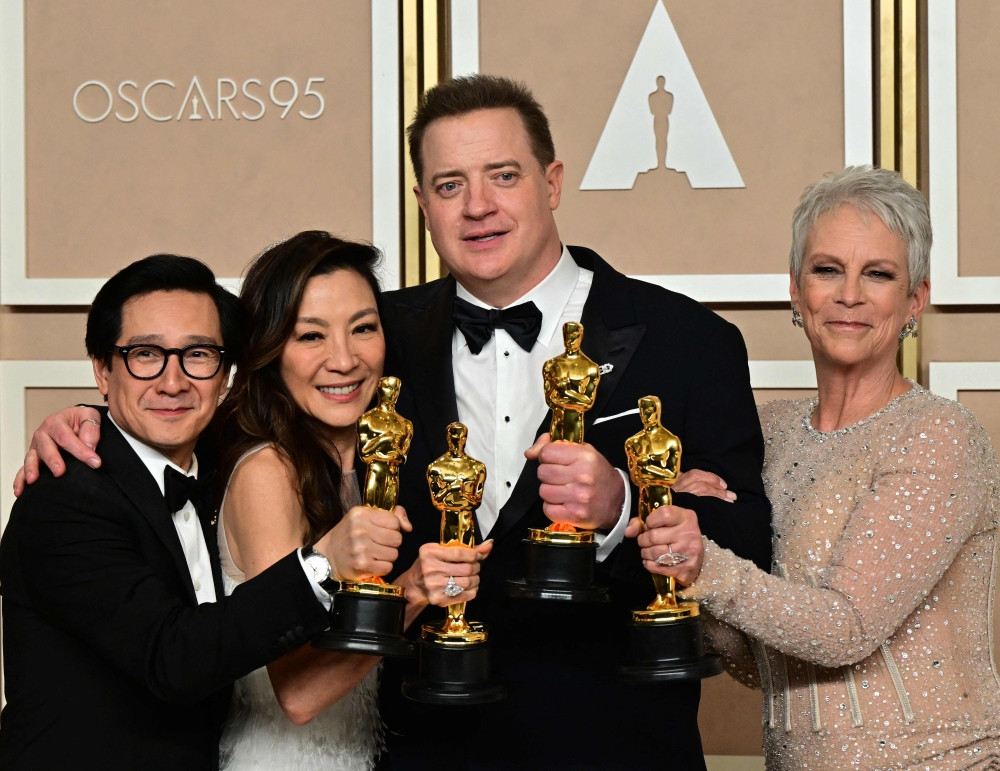 (From L) Best Actor in a Supporting Role US-Vietnamese actor Ke Huy Quan, Best Actress in a Leading Role Malaysian actress Michelle Yeoh, Best Actor in a Leading Role US actor Brendan Fraser, and Best Actress in a Supporting Role winner US actress Jamie Lee Curtis poses with their Oscar trophies in the press room during the 95th Annual Academy Awards at the Dolby Theatre in Hollywood, California on March 12, 2023. (Photo by Frederic J. Brown / AFP)