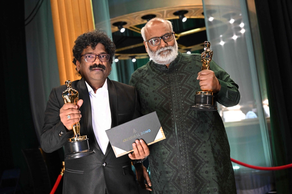 In this handout photo provided by the Academy of Motion Picture Arts and Sciences (AMPAS) Indian lyricist Chanrabose and Indian musical composer M.M. Keeravaani hold the Oscar for Best Music (Original Song) for their song 