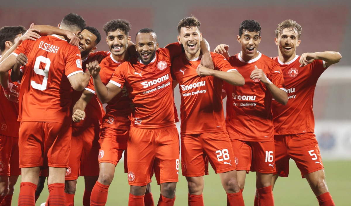 Al Arabi's Youssef Msakni (third right) celebrates with teammates.