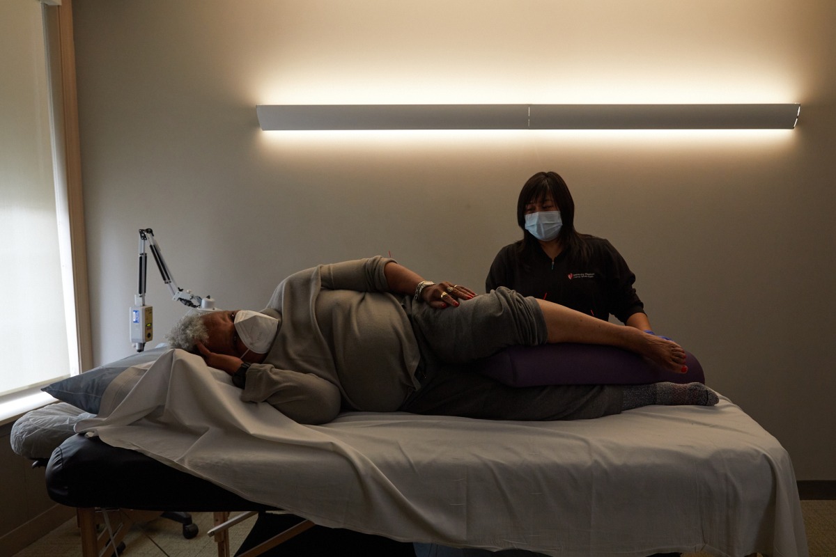 Pat Hill, who has long-covid symptoms, receives acupuncture treatment from Gayla Marie Stiles at University Hospitals Connor Whole Health in Rocky River, Ohio. The Washington Post/Da'Shaunae Marisa.
