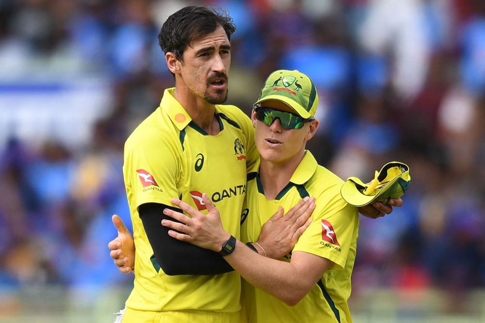 Australia's Mitchell Starc (L) celebrates after taking the wicket of India's Mohammed Siraj (not pictured) during the second one-day international (ODI) cricket match between India and Australia at the Y.S. Rajasekhara Reddy Cricket Stadium in Visakhapatnam on March 19, 2023. (Photo by Noah SEELAM / AFP)