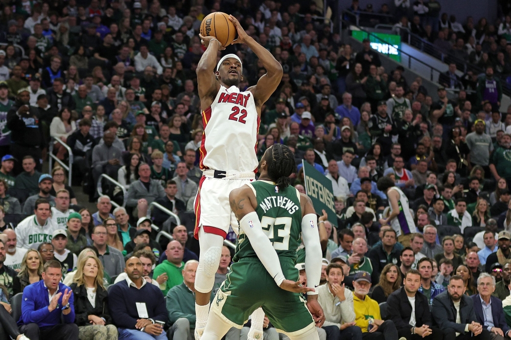 Jimmy Butler #22 of the Miami Heat shoots over Wesley Matthews #23 of the Milwaukee Bucks during the second half of Game 5 of the Eastern Conference First Round Playoffs at Fiserv Forum on April 26, 2023 in Milwaukee, Wisconsin.  Stacy Revere/Getty Images/AFP 