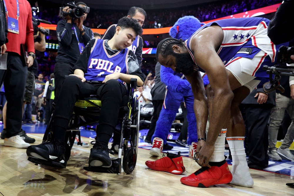 James Harden #1 of the Philadelphia 76ers gives his game sneakers to Michigan State shooting survivor John Hao after defeating the Boston Celtics in game four of the Eastern Conference Second Round Playoffs at Wells Fargo Center on May 07, 2023 in Philadelphia, Pennsylvania. (Photo by Tim Nwachukwu / GETTY IMAGES NORTH AMERICA / Getty Images via AFP)
