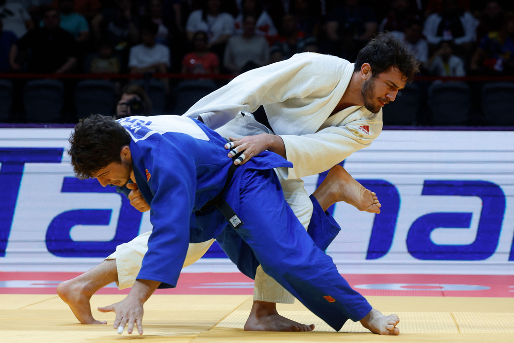 Georgia’s Luka Maisuradze and Lasha Bekauri (white) compete in the men’s -90kg final bout. Picture: AFP