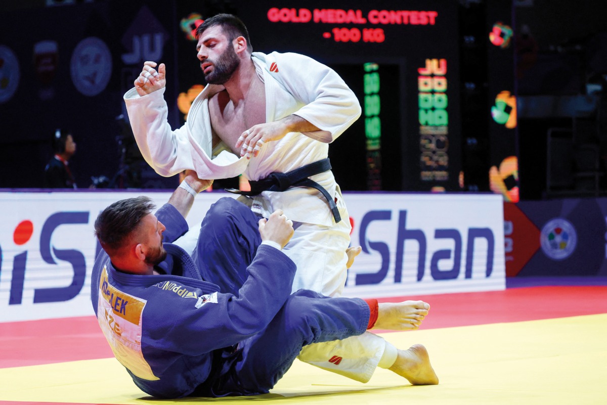 Russia’s Arman Adamian (white) competes with Czech Republic’s Lukas Krpalek (blue) in their men’s -100Kg final bout. AFP