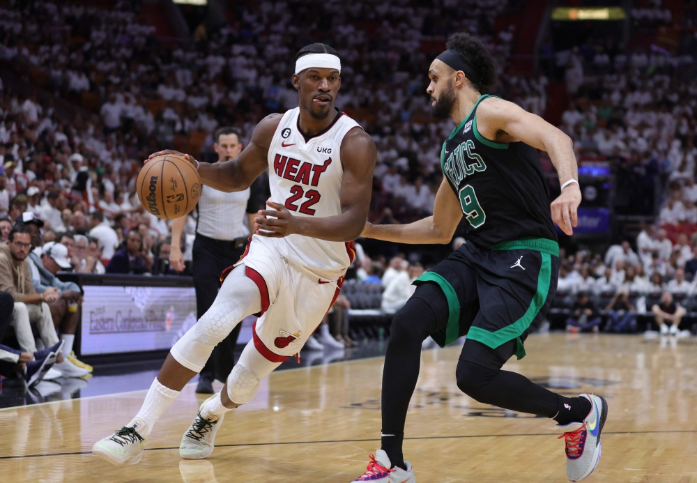 Jimmy Butler #22 of the Miami Heat drives against Derrick White #9 of the Boston Celtics during the third quarter in game three of the Eastern Conference Finals at Kaseya Center on May 21, 2023 in Miami, Florida. Photo by Megan Briggs / GETTY IMAGES NORTH AMERICA / Getty Images via AFP