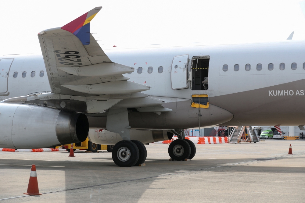 An opened door of an Asiana Airlines plane is seen at Daegu International Airport in Daegu on May 26, 2023, after it was manually opened by a passenger just 200 metres above the ground before landing causing some to have breathing difficulty but with no major injuries. 