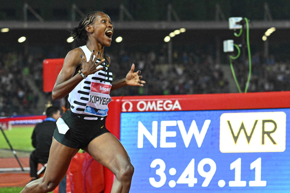 Kenya's Faith Kipyegon reacts as she wins the Women's 1500m event, setting a new world record of 3:49.11, during the Wanda Diamond League 2023 Golden Gala on June 2, 2023 at the Ridolfi stadium in Florence, Tuscany. (Photo by Filippo Monteforte / AFP)