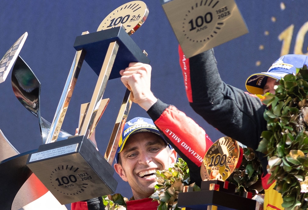 Ferrari N.51 499P Hypercar drivers Italian Alessandro Pier Guidi celebrates on the podium after winning the endurance race 24 hours of Le Mans on June 11, 2023. This year marks the 100th anniversary of the race. (Photo by Fred TANNEAU / AFP)