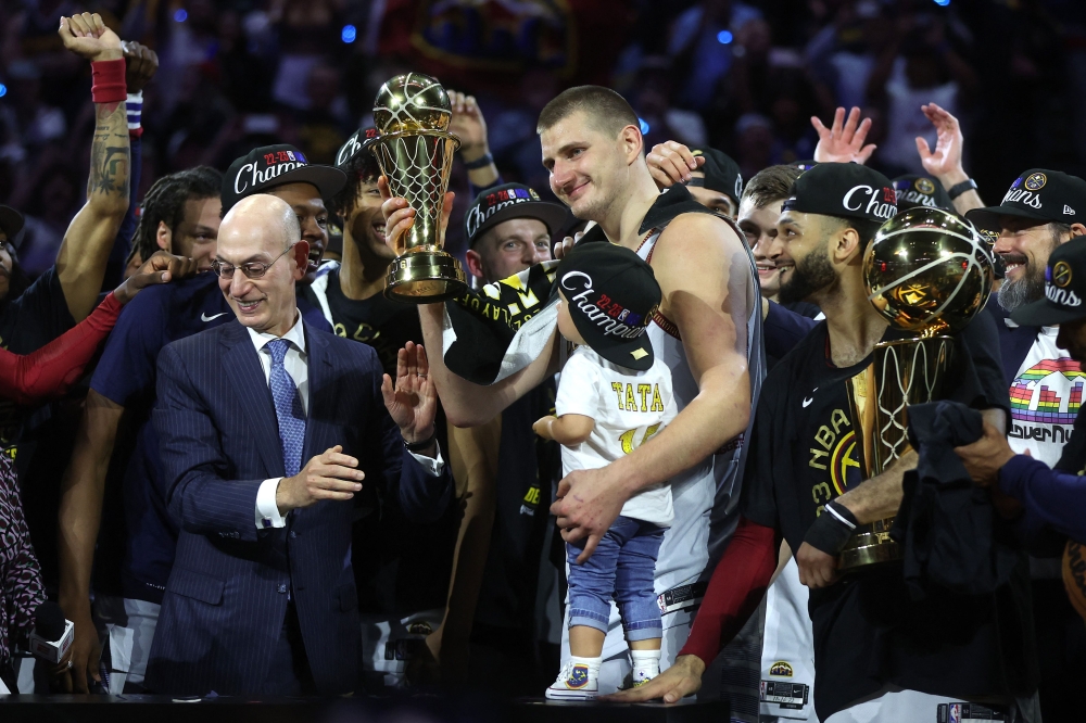 Nikola Jokic #15 of the Denver Nuggets is presented the Bill Russell NBA Finals Most Valuable Player Award after a 94-89 victory against the Miami Heat in Game Five of the 2023 NBA Finals to win the NBA Championship at Ball Arena on June 12, 2023 in Denver, Colorado.  Photo by MATTHEW STOCKMAN /  AFP
