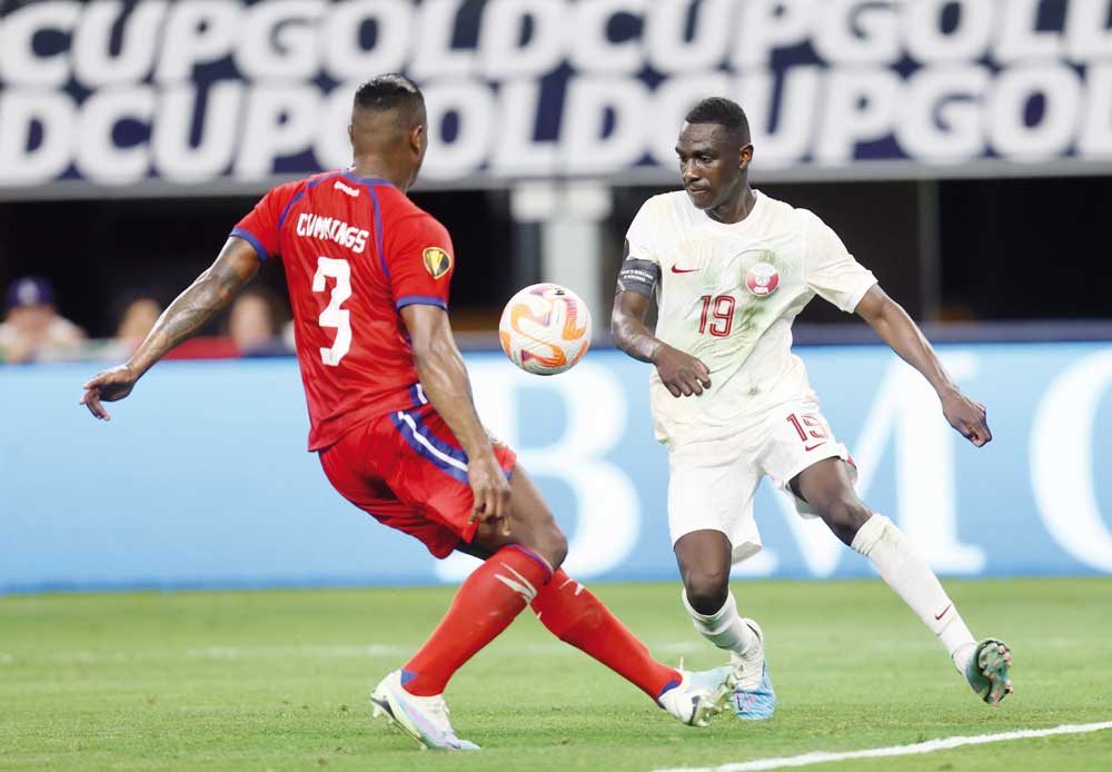 Qatar's Almoez Ali (right) in action against a Panama player during their Gold Cup quarter-final yesterday.