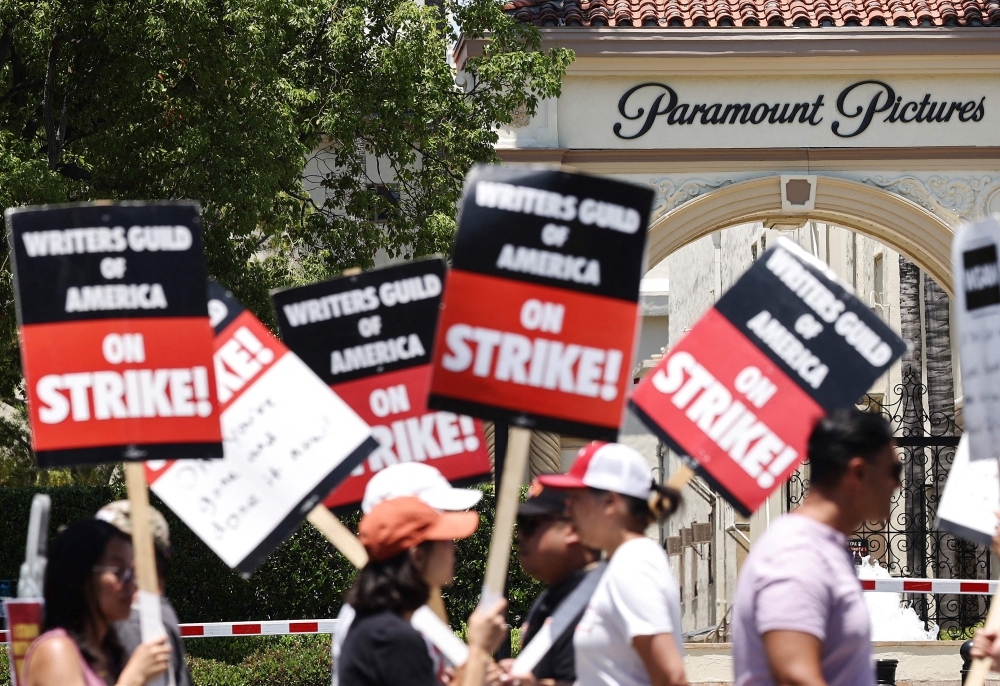 Striking WGA (Writers Guild of America) workers picket outside Paramount Studios on July 12, 2023 in Los Angeles, California. Photo by MARIO TAMA / GETTY IMAGES NORTH AMERICA / Getty Images via AFP