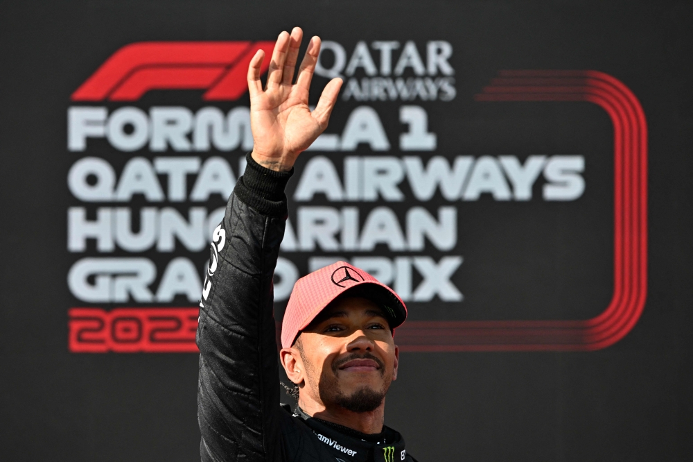 Pole position winner Mercedes' British driver Lewis Hamilton waves to fans after the qualifying session at the Hungaroring race track in Mogyorod near Budapest on July 22, 2023, ahead of the Formula One Hungarian Grand Prix. (Photo by ATTILA KISBENEDEK / AFP)
