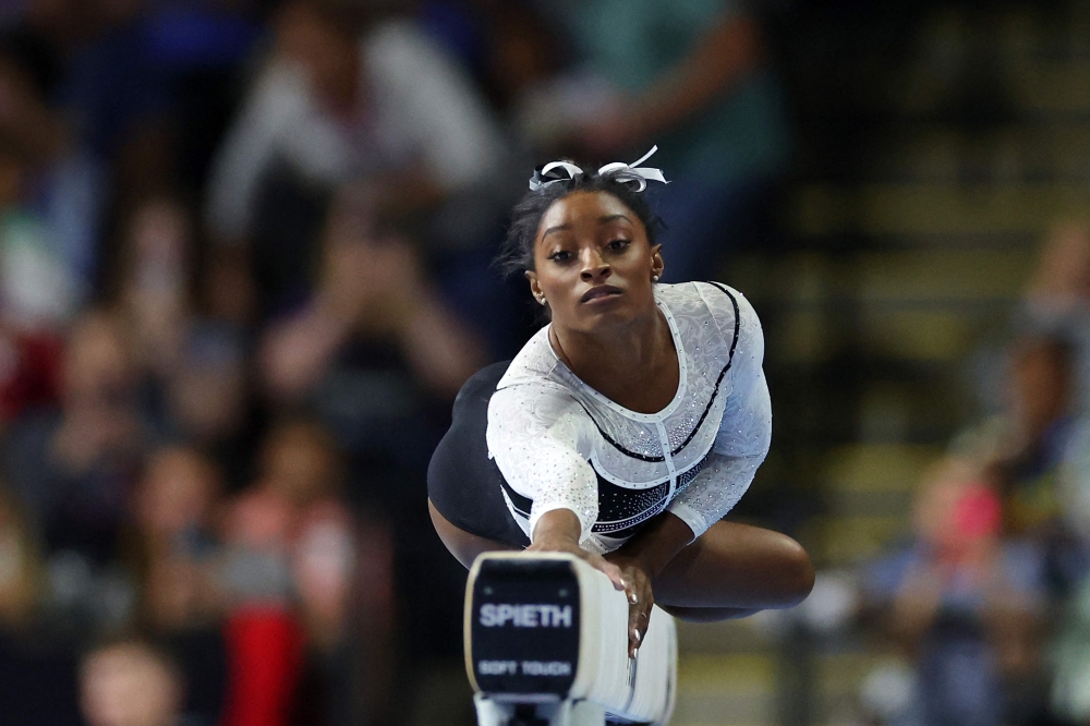 Simone Biles competes on the balance beam during the Core Hydration Classic at Now Arena on August 05, 2023 in Hoffman Estates, Illinois. Stacy Revere/Getty Images/AFP