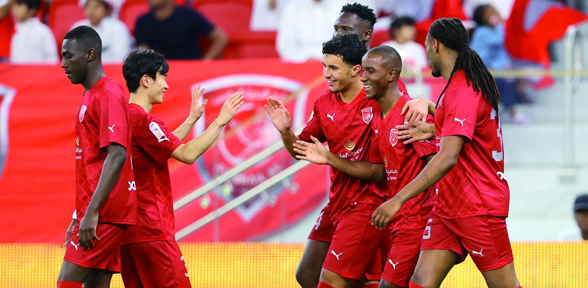 Al Duhail's Ibrahima Diallo (second right) celebrates with teammates