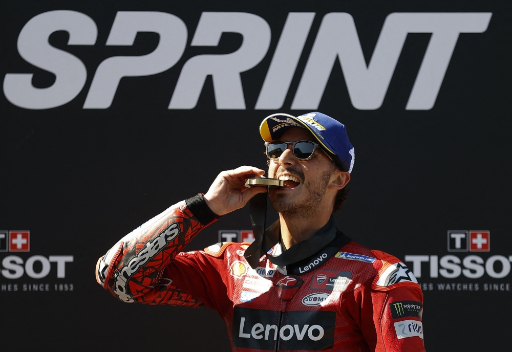 Ducati Lenovo Team Italian rider Francesco Bagnaia celebrates with his medal on the podium after winning the sprint race at the Red Bull Ring race track in Spielberg, Austria on August 19, 2023, ahead of the MotoGP Austrian Grand Prix. (Photo by ERWIN SCHERIAU / APA / AFP) / Austria OUT
