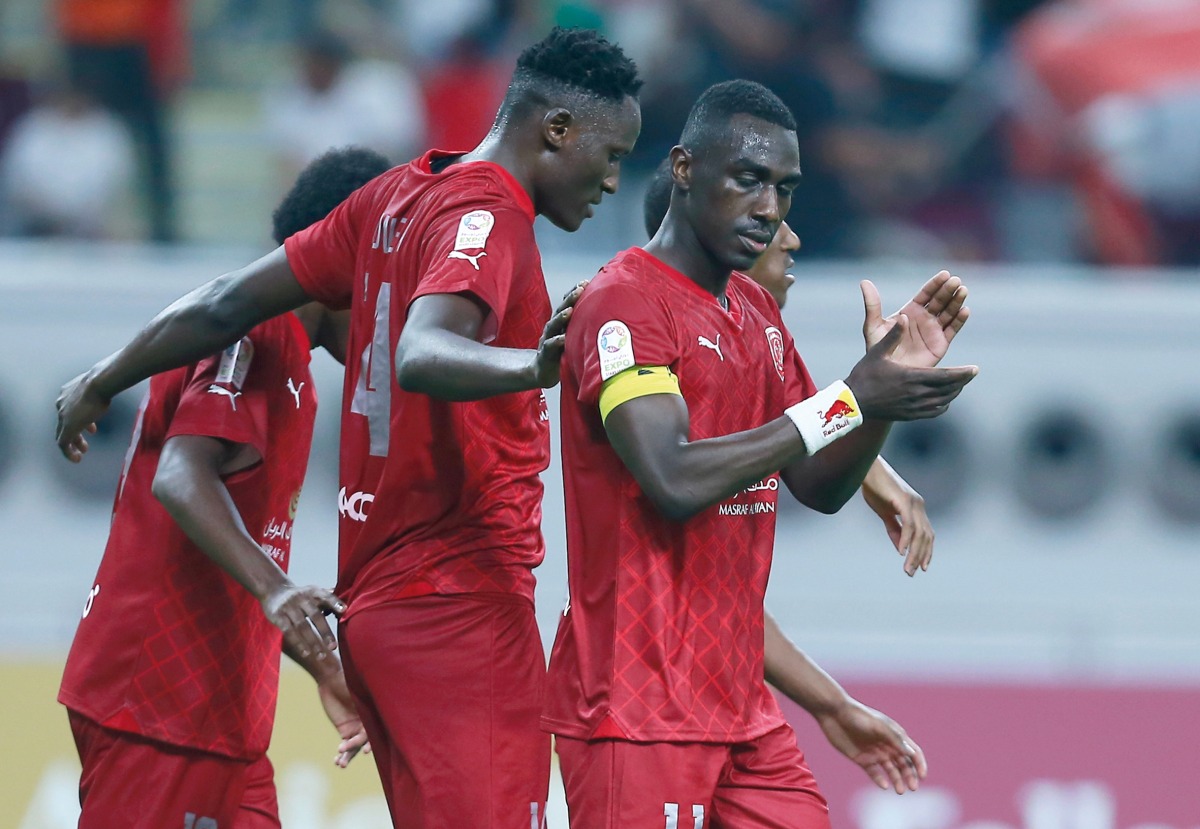 Al Duhail's Michael Olunga (centre) celebrates with teammates after scoring a goal. Pic: Rajan Vadakkemuriyil