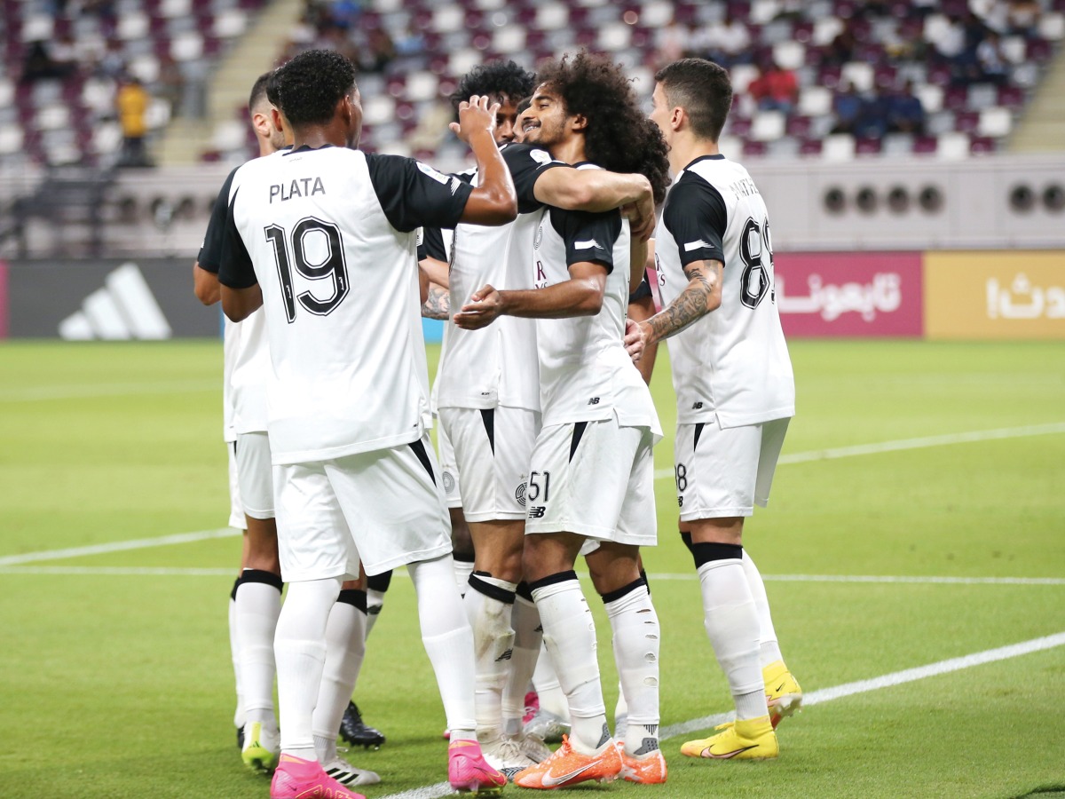 Al Sadd's Akram Afif celebrates with teammates.