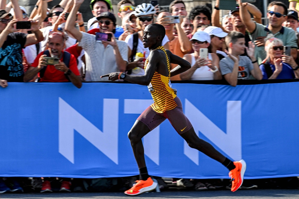 Uganda's Victor Kiplangat reacts as he comptes in the men's marathon final during the World Athletics Championships in Budapest on August 27, 2023. (Photo by Ferenc ISZA / AFP)