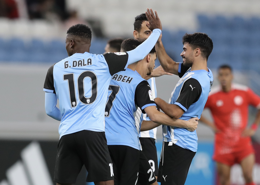 Al Wakrah players celebrate after Gelson Dala scored their first goal. 