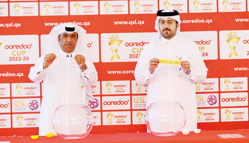 Officials pick Qatar SC during the draw ceremony.