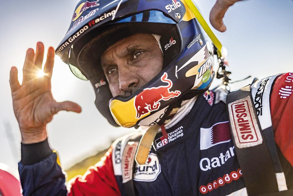 Al Attiyah gestures after finishing the stage.   