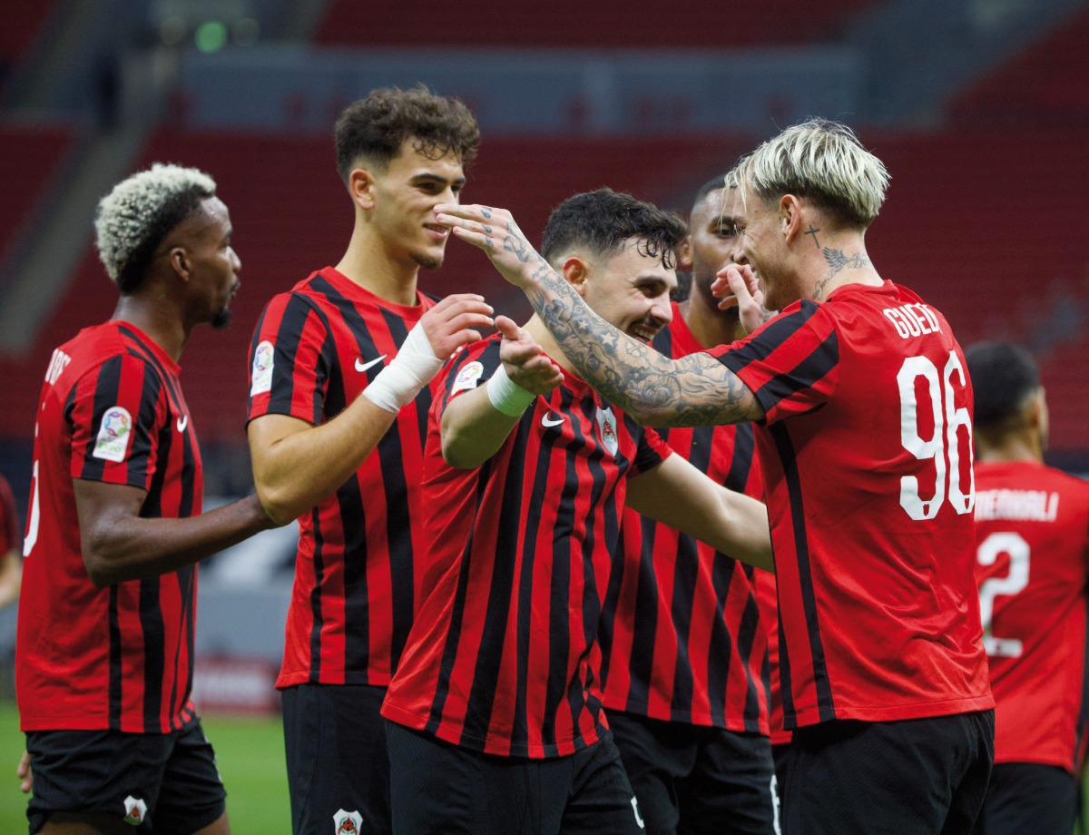 Al Rayyan's Roger Guedes (right) celebrates with teammates after scoring his second goal on Saturday.