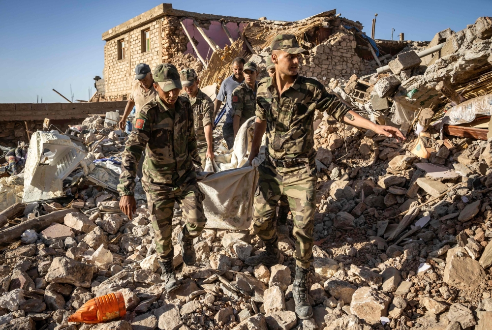 Moroccan Royal Armed Forces evacuate a body from a house destroyed in an earthquake in the mountain village of Tafeghaghte, southwest of the city of Marrakesh, on September 9, 2023. Photo by FADEL SENNA / AFP)
