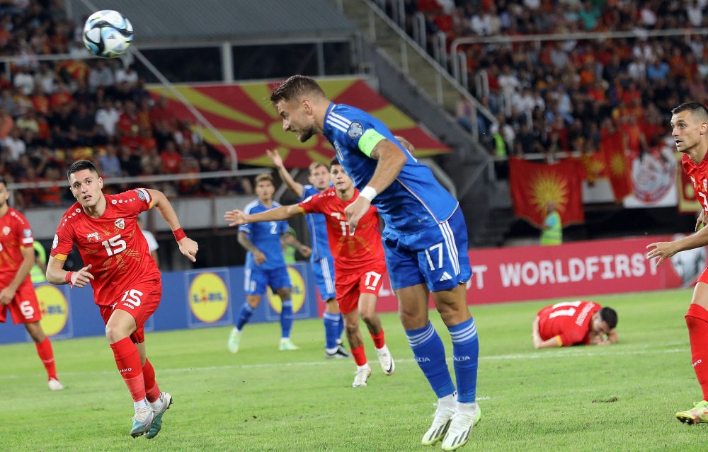 Italy's forward Ciro Immobile (C) heads the ball and scores a goal during the UEFA Euro 2024 group C qualification football match between North Macedonia and Italy, in Skopje, on September 9, 2023. (Photo by Robert ATANASOVSKI / AFP)