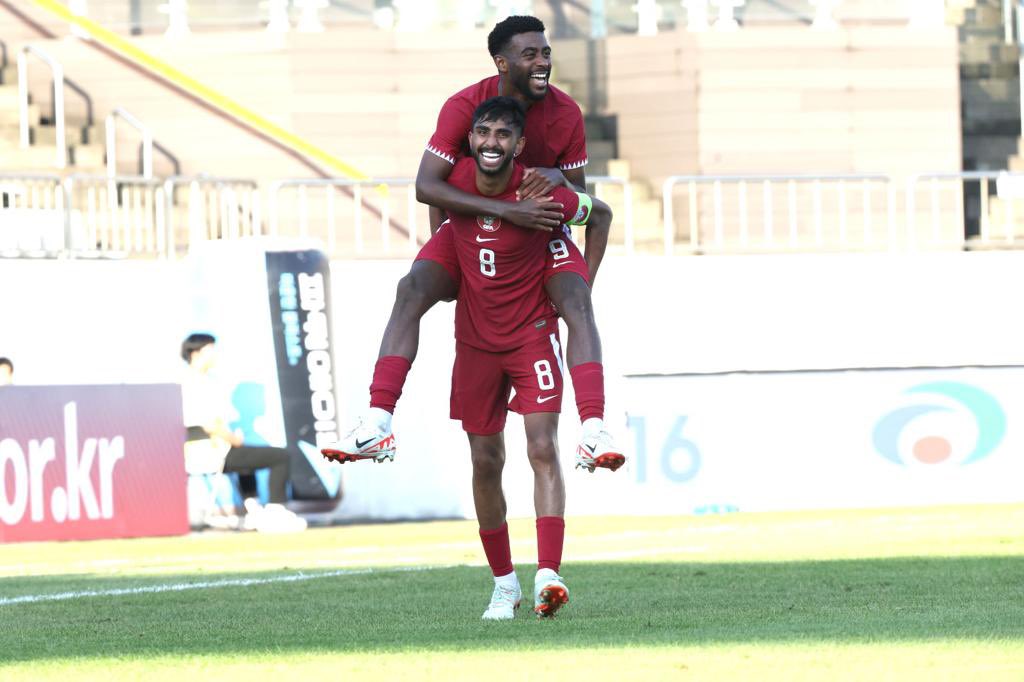 Qatar players celebrate during the match.