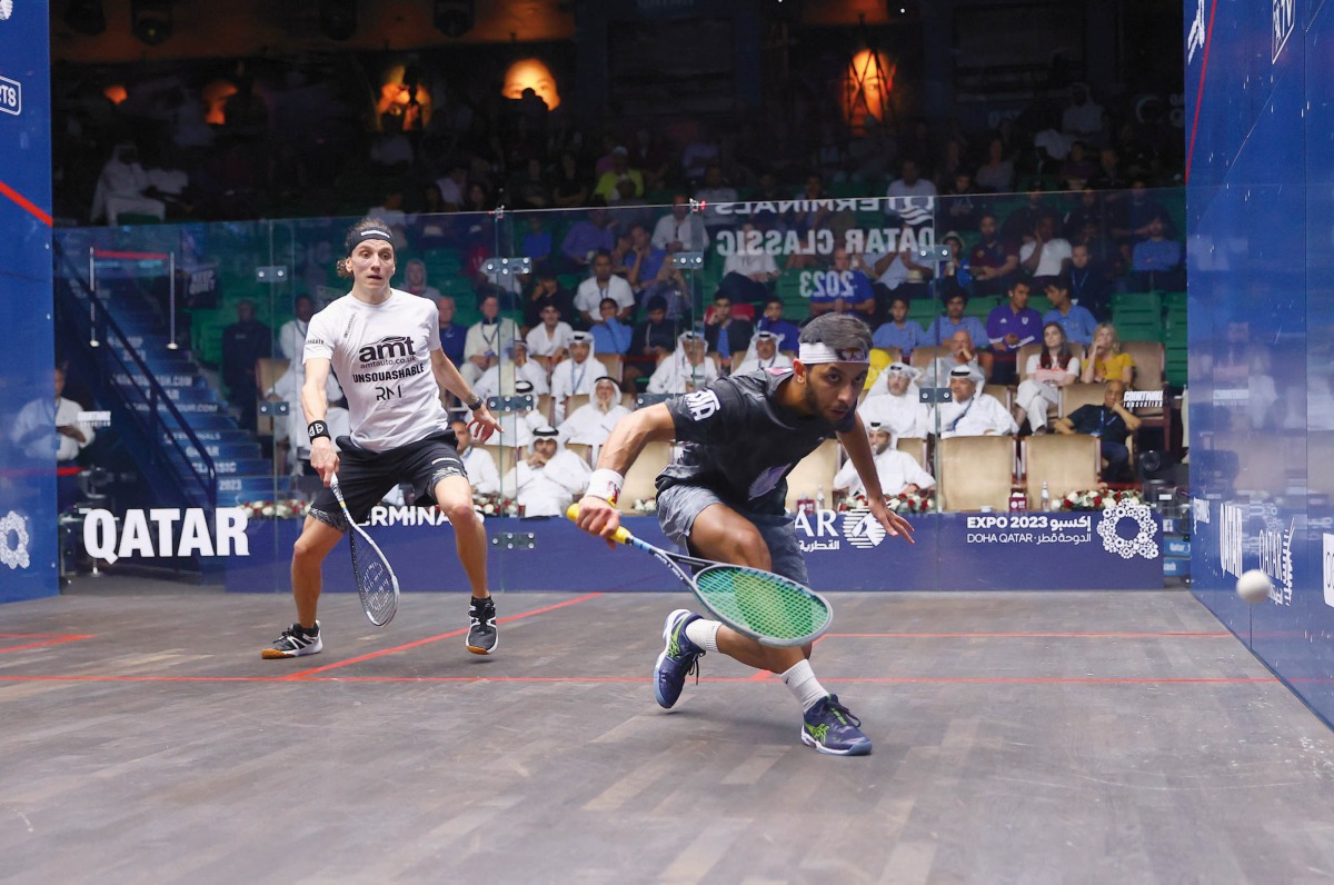 Qatar's Abdulla Mohamed Al Tamimi (left) in action against Frenchman Lucas Serme during their QTerminals Qatar Classic first round match, yesterday.
