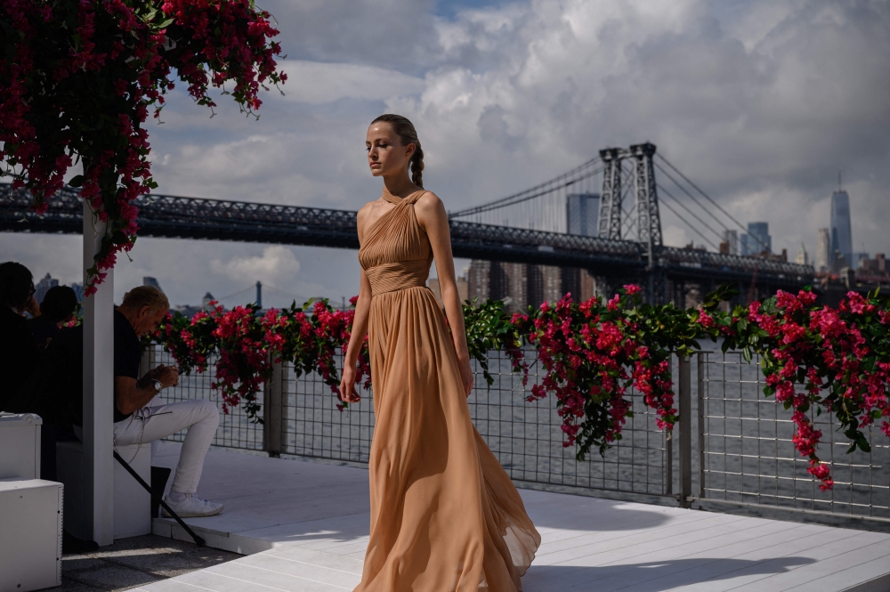 A model presents designs by US fashion designer Michael Kors during his New York Fashion Week runway show in the Brooklyn borough of New York City on September 11, 2023. (Photo by Ed Jones / AFP)