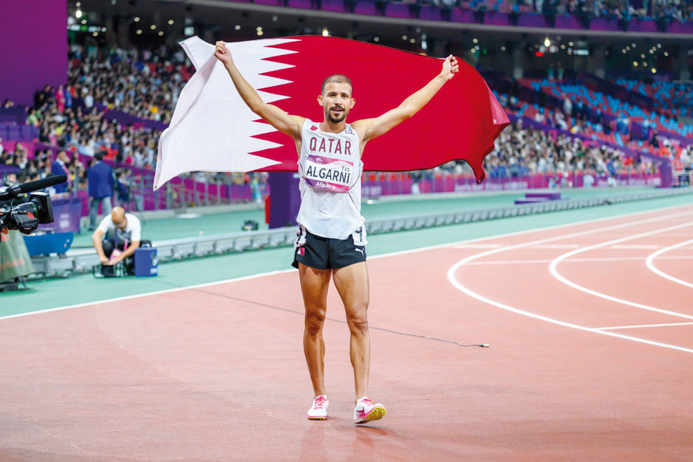 Mohamad Al Garni celebrates with Qatar flag after winning the gold.