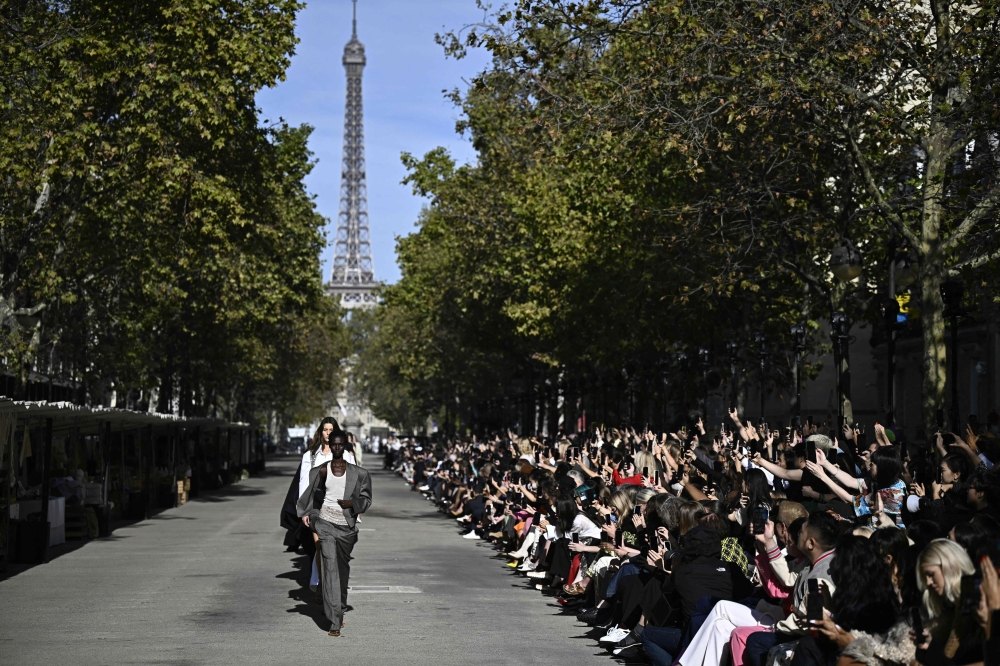 Models present creations by British designer Stella McCartney during her show next to the eiffel tower as part of the Womenswear Spring/Summer 2024 Paris Fashion Week in Paris on October 1, 2023. (Photo by Julien De Rosa / AFP)