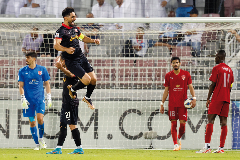 Persepolis’ Iranian midfielder Omid Alishah (center) celebrates after scoring a goal against Al Duhail at Abdullah bin Khalifa Stadium in Doha, yesterday. AFP