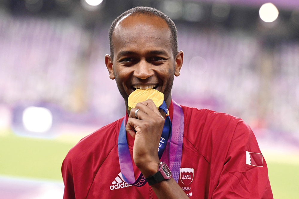 Mutaz Barshim celebrates on the podium. AFP