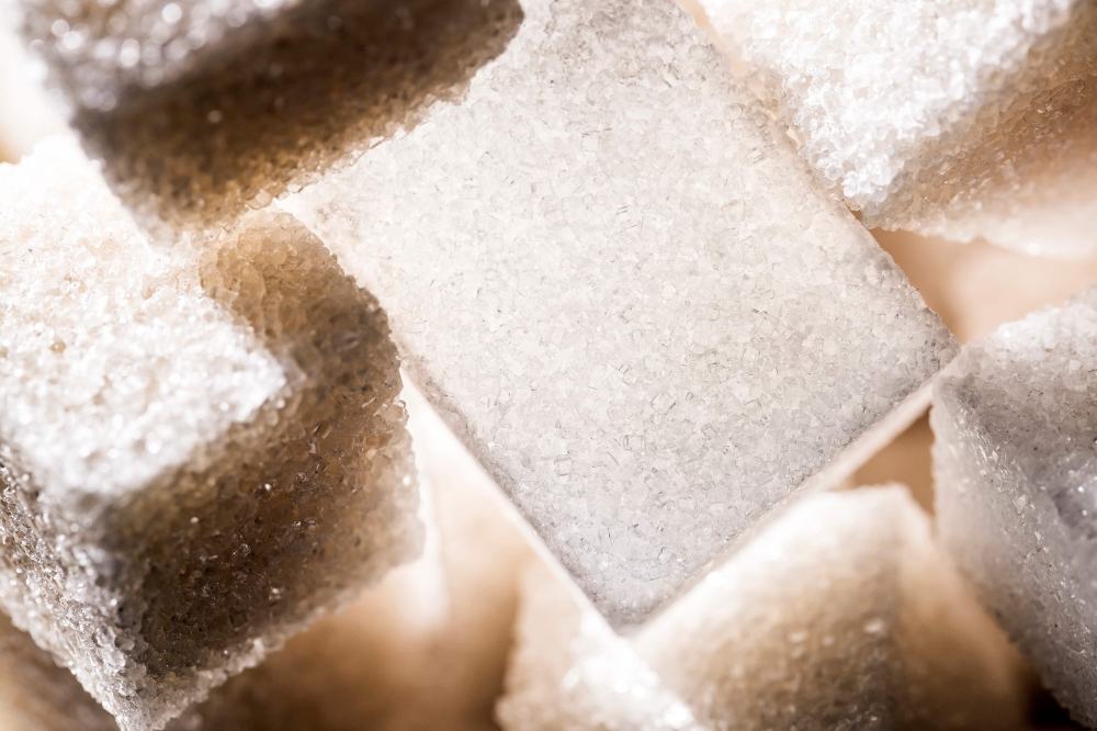 This photograph taken on November 21, 2017, shows an arrangement of white and cane sugar cubes in Paris. Photo by JOEL SAGET / AFP