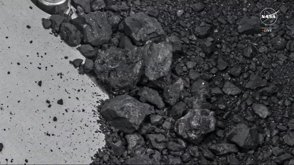 In this still image from a NASA TV broadcast from Houston, Texas, on October 11, 2023, shows the OSIRIS-REx sample collector with sample material from asteroid Bennu. (Photo by Handout / NASA TV / AFP) 

