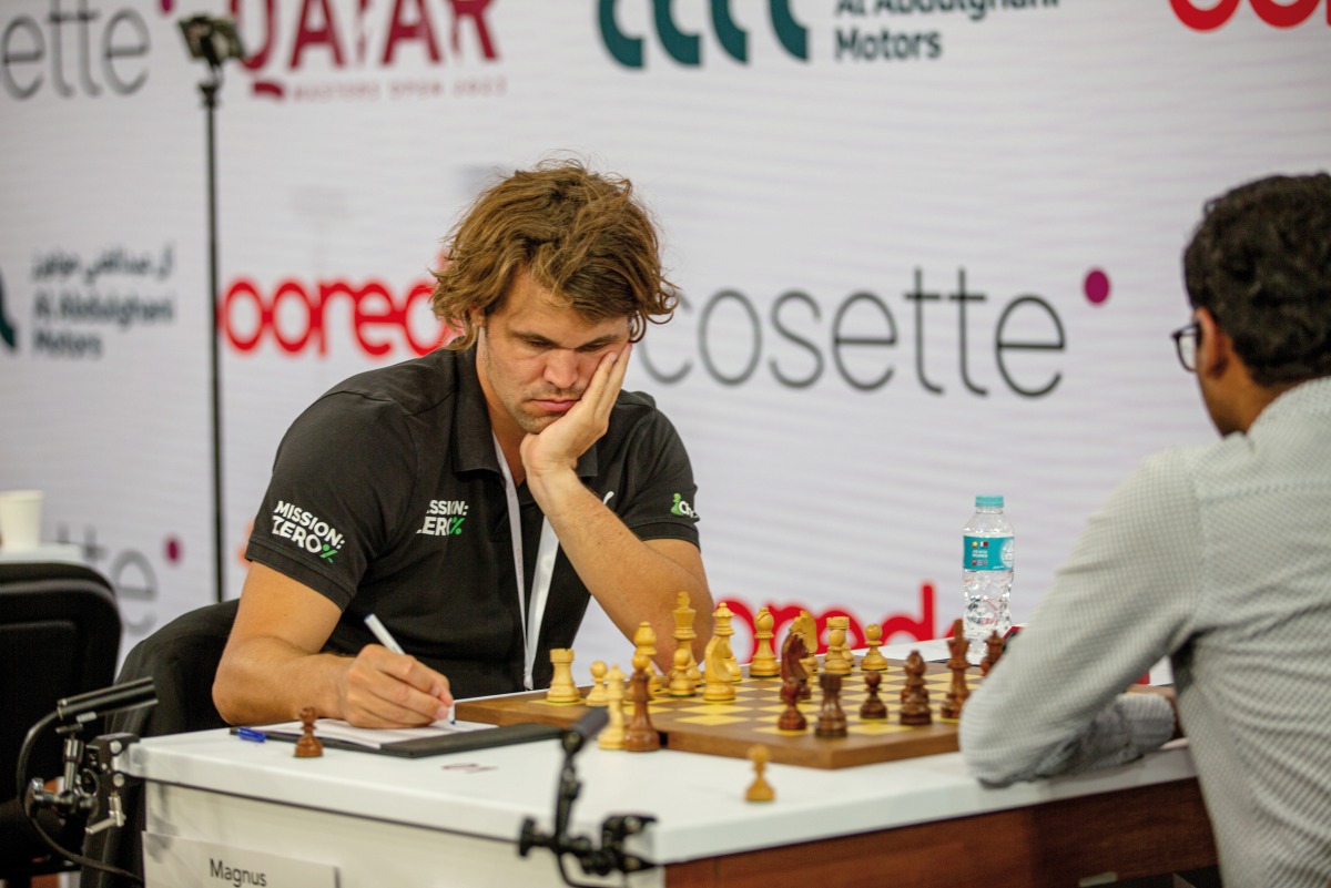 Magnus Carlsen (left) records a move during his game against Muthaiah AL.