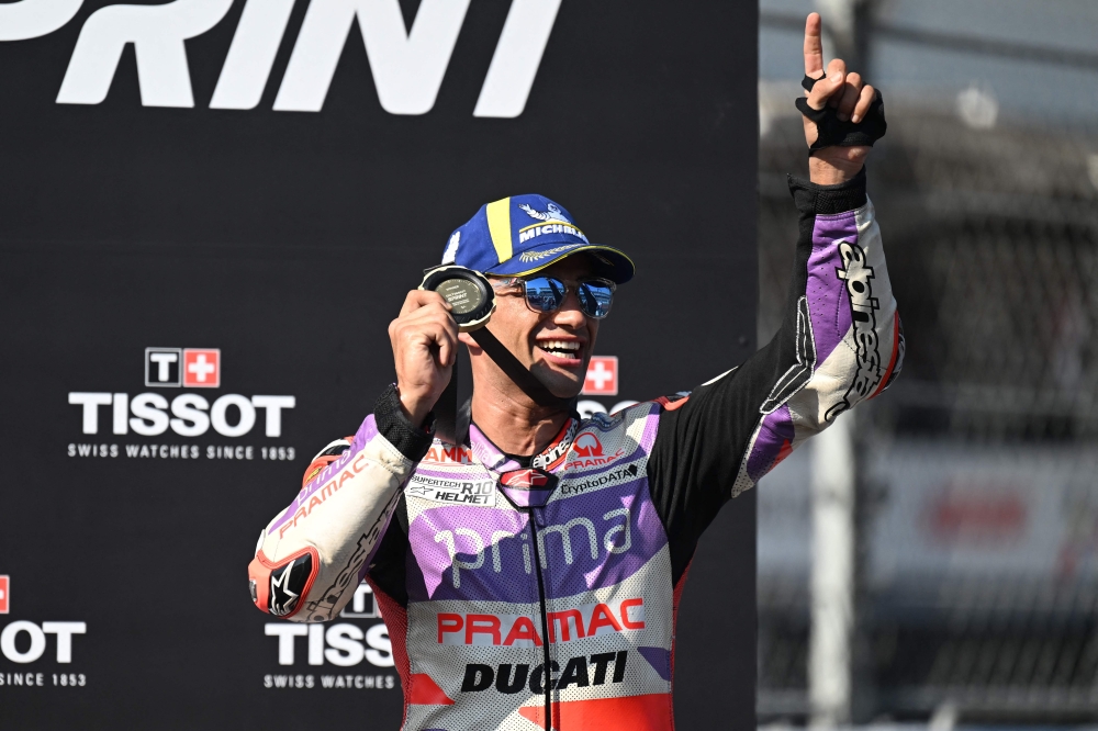 First-placed Prima Pramac Racing Spanish rider Jorge Martin celebrates on the podium following the sprint race of the Indonesian Grand Prix MotoGP on October 14, 2023. (Photo by Sonny Tumbelaka / AFP)